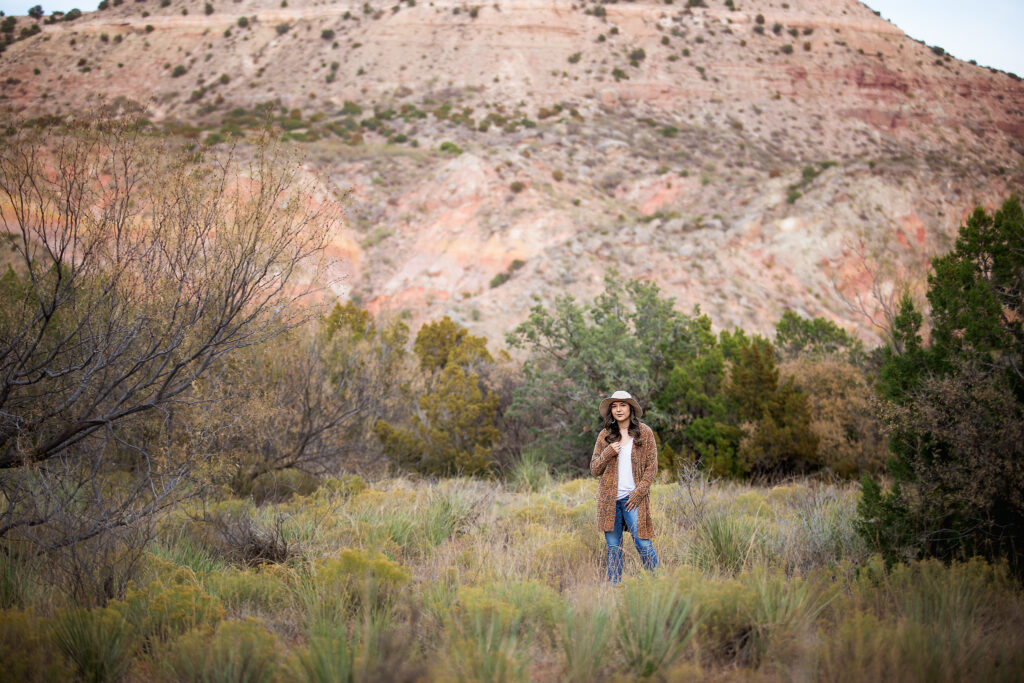 Girl standing in the grass at palo duro canyon
