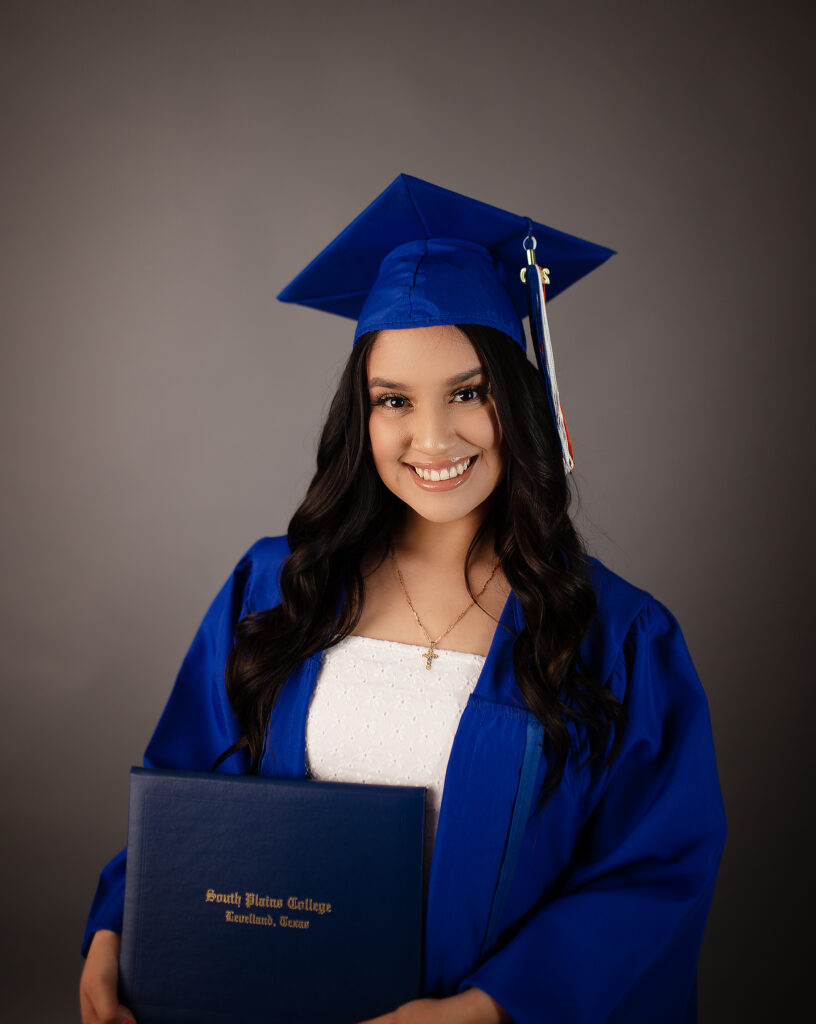College grand in blue cap & gown for South Plains College. 