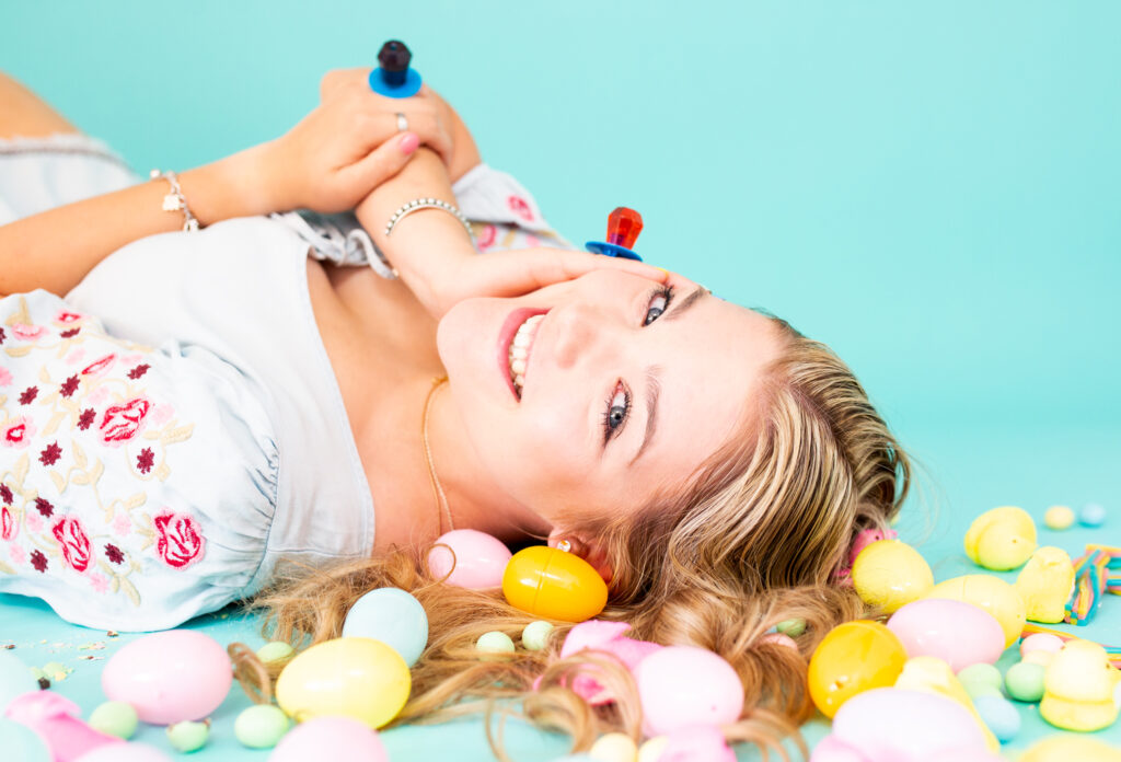 Blonde haired senior girl laying in Easter Candy