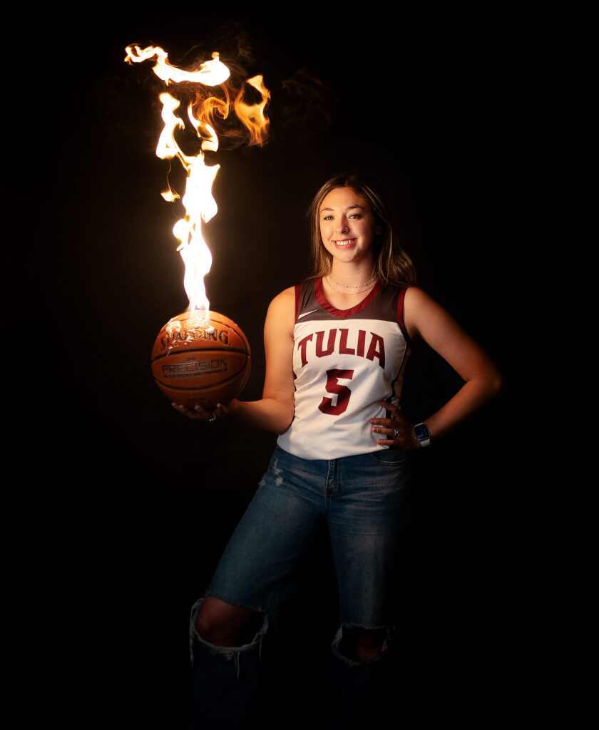 Tulia high school basketball player with a basketball on fire 