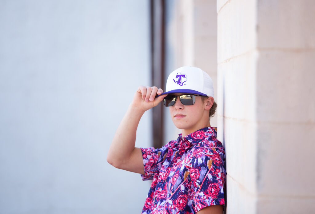 Senior boy in a Hawaiian shirt , sunglasses & hat 